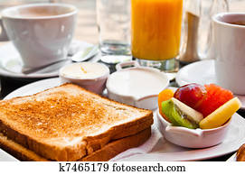 Breakfast with orange juice and fresh fruits on table Breakfast with orange juice and fresh fruits on table