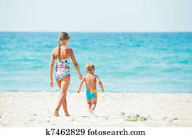 Young girl and boy playing happily at pretty beach