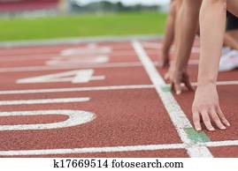 Cropped people ready to race on track field