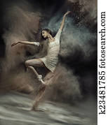 Dancing ballet dancer with dust in the background Dancing ballet dancer with dust in the background