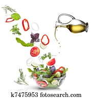 Falling vegetables for salad and oil isolated on white Falling vegetables for salad and oil isolated on white