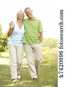 Mature couple walking in countryside Mature couple walking in countryside