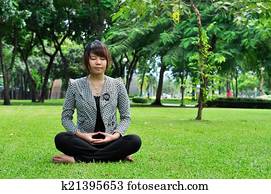 Meditation woman on green grass