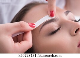 Pretty girl getting brow depilation Pretty girl getting brow depilation