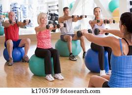 Instructor Taking Exercise Class At Gym Instructor Taking Exercise Class At Gym