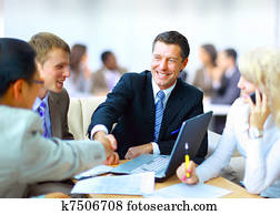 Business people shaking hands, finishing up a meeting Business people shaking hands, finishing up a meeting