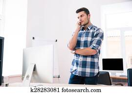 Businessman talking on the phone in office