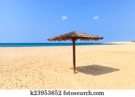 Beach scenery with parasol in Boavista, Cape Verde 