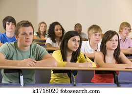 Students in class paying attention and taking notes (depth of field)