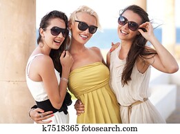 Three adorable women wearing sunglasses