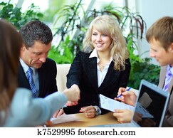 Business people shaking hands, finishing up a meeting Business people shaking hands, finishing up a meeting