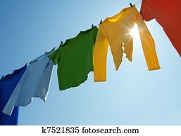 Colorful clothes on a laundry line and sun shining