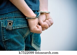 Young man in handcuffs