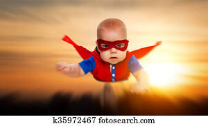 toddler little baby superman superhero with a red cape flying through sky toddler little baby superman superhero with a red cape flying through sky