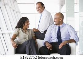 Office workers meeting in lobby
