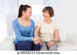 Caregiver Consoling Senior Woman