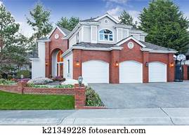 Luxury house exterior with three car garage and driveway