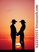 cowboy and cowgirl at sunset cowboy and cowgirl at sunset