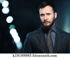 Handsome well-dressed man in jacket with beard and mustache 