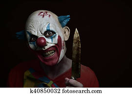 Evil Clown With The Word Halloween In His Arm Stock Photo