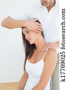 Male chiropractor doing neck adjustment Male chiropractor doing neck adjustment