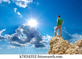 Man on peak of mountain.