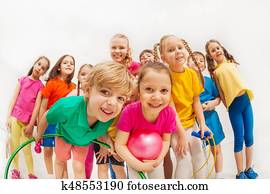 Sporty kids and gymnastics coach having fun in gym Sporty kids and gymnastics coach having fun in gym