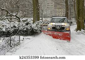 Truck with snowplow on road in snow Truck with snowplow on road in snow