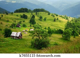 mountain valley and wooden house