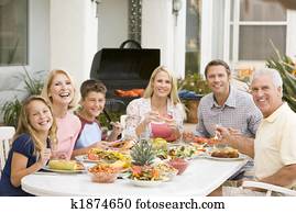 Family Enjoying A Barbeque Family Enjoying A Barbeque