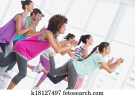 Fitness class and instructor doing pilates exercise Fitness class and instructor doing pilates exercise