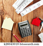 Calculator,Mini House and Sketch on Wooden Table