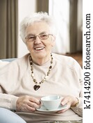 Senior Woman Enjoying Cup Of Tea At Home