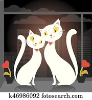Two cats sitting on the window on the background of the city Two cats sitting on the window on the background of the city