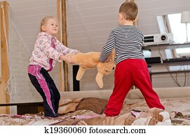Cute brother and sister having a tug of war
