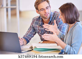 Man paying attention to his female business counterpart while working