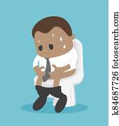 African Businessman sitting on the toilet with his stomach ache and possibly a bowel disease African Businessman sitting on the toilet with his stomach ache and possibly a bowel disease