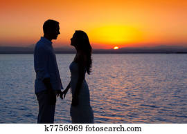 couple in love back light silhouette at lake sunset couple in love back light silhouette at lake sunset