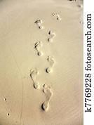 human adult footprint in the fine sand at the beach