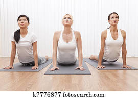 Interracial Group of Three Beautiful Women In Yoga Position