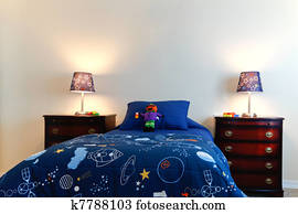 Blue boys bed with two lamps in a white bedroom Blue boys bed with two lamps in a white bedroom