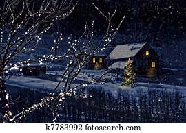 Snowy winter scene of a cabin in distance Snowy winter scene of a cabin in distance