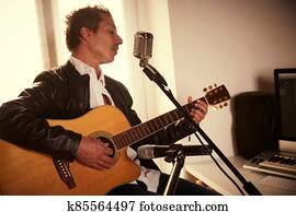 guitar player recording at home studio