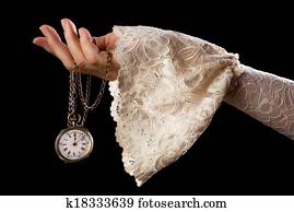 Hand holding antique watch