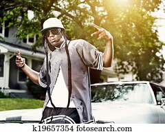 young black man making hand signs in front of car young black man making hand signs in front of car