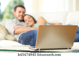 Couple watching tv in a laptop