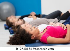 Aerobics class practising deep breathing