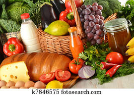 Groceries in wicker basket including vegetables and fruits Groceries in wicker basket including vegetables and fruits