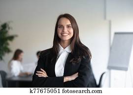Headshot portrait businesswoman posing with arms crossed indoors Headshot portrait businesswoman posing with arms crossed indoors