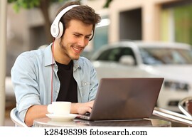 Student learning with a laptop in a bar